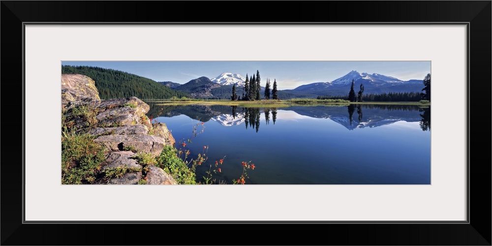 USA, Oregon, Sparks Lake. Red Columbine grow from a rock outcrop at Sparks Lake in the Cascades Range of Oregon.