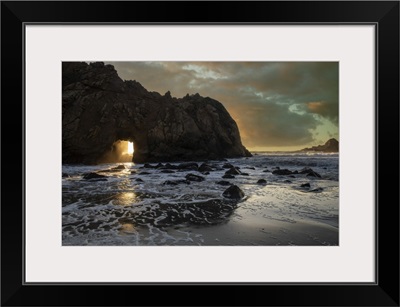 Sunset Shines Through A Tunnel In This Sea Rock At Big Sur