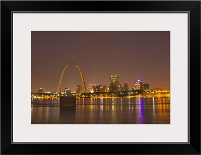 The Gateway Arch and St Louis skyline reflect into the Mississippi River