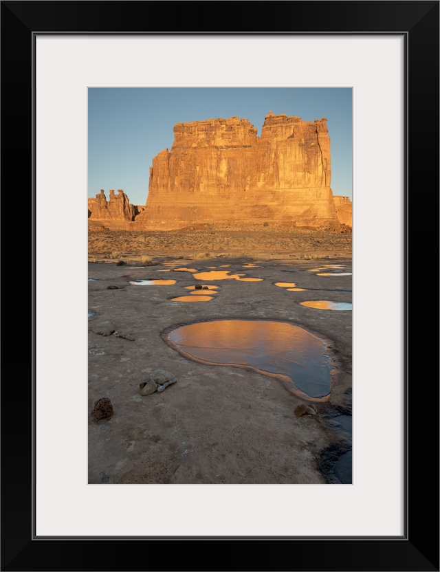 North America, USA, Utah, Arches National Park.  Reflected light  from the Organ in icy pot holes, Arches National Park, UT