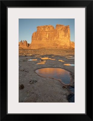 Utah, Arches National Park. Reflected light from the Organ in icy pot holes