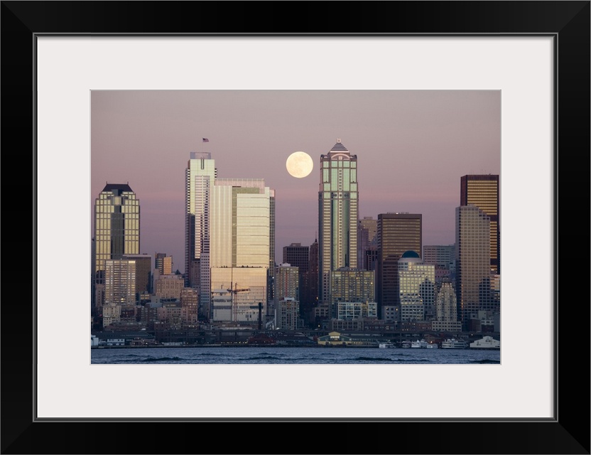 Washington, Seattle skyline and Elliott Bay with full moon rising, view from Alki.