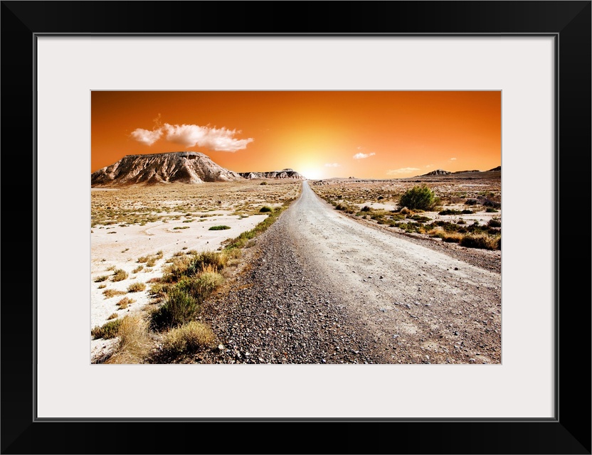 Sunset desert landscape with road.