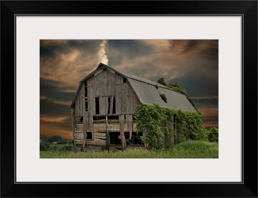 Dilapidated old barn with sunset sky.