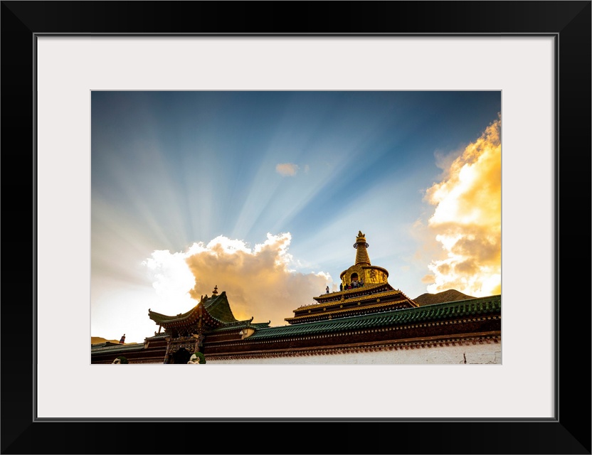 China, Gansu, Xiahe, Ray of sunlight over the Gong Tang pagoda of Labrang Monastery.