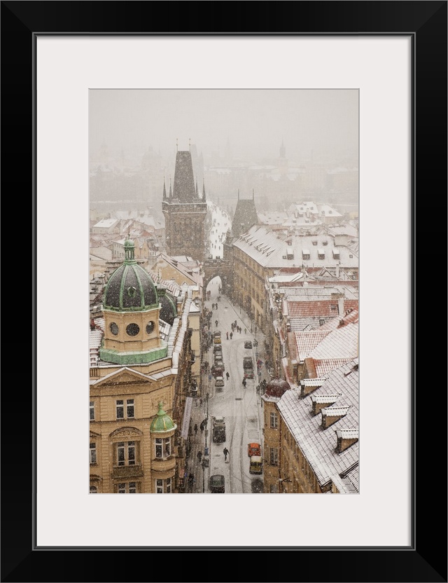 Czech Republic, Central Bohemia Region, Prague, Bohemia, Central Europe, View of the town under the snow from St Nicholaus...