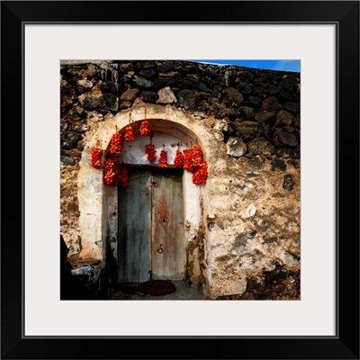 Italy, Sicily, Pantelleria Island, typical door with hanging drying tomatoes