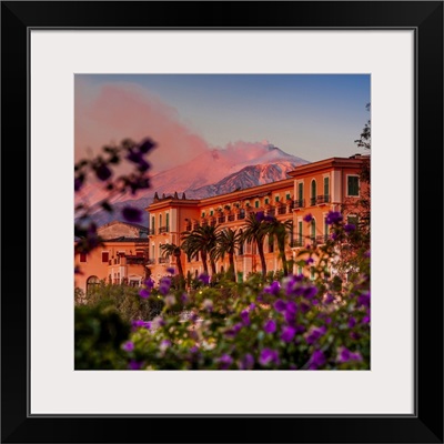 Italy, Taormina, San Domenico Palace Hotel at sunset with Mount Etna in the background