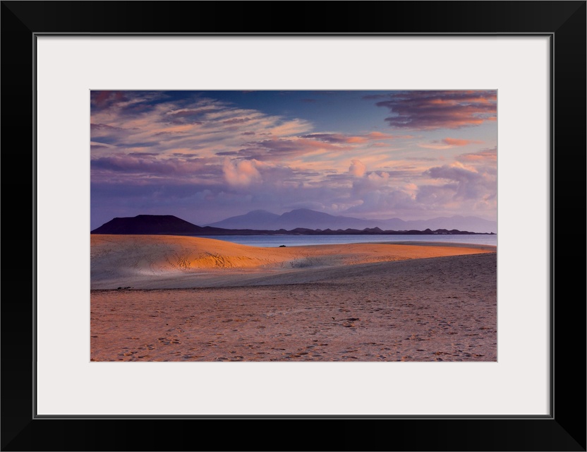 Spain, Canary Islands, Atlantic ocean, Fuerteventura, Corralejo, Corralejo Dunes National Park at sunset with Lobos Island...