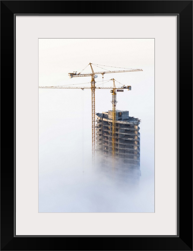 United Arab Emirates, Dubai, Dubai City, Construction in early morning fog.