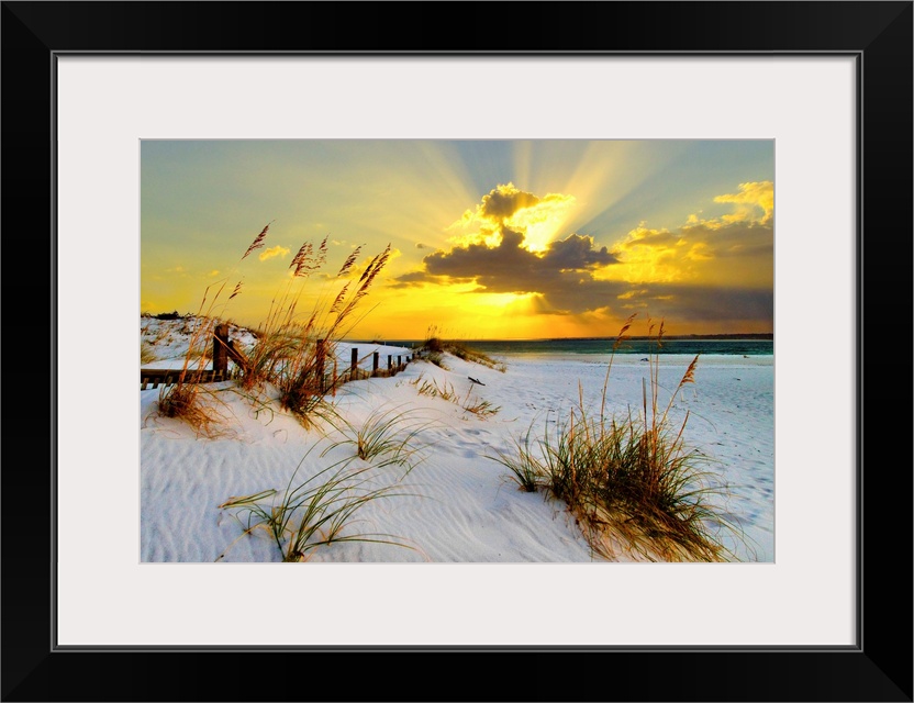 Landscape photograph of a golden beach sunset along a beautiful coast. This golden sunset has magnificent golden light bre...