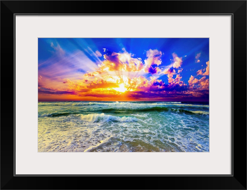 A purple and blue sunset over a green sea. The reflection of the orange, purple and blue sunset hit the sea and shore belo...