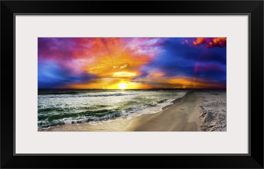 A dark rainbow sunset with a beautiful blue, purple and red sky. This is a large beach panorama.