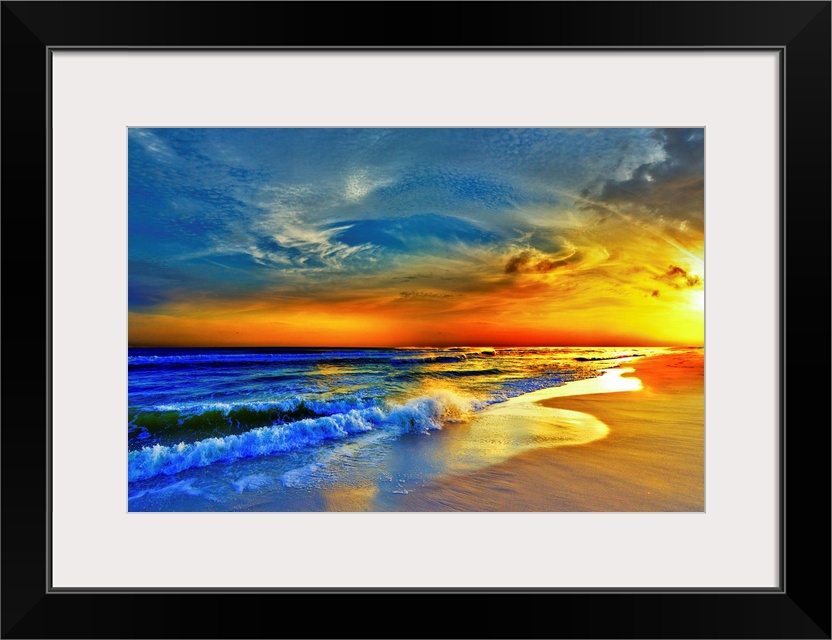 A sandy beach before a bright burning red sunset.  Waves crash onto the sandy sea shore. Landscape taken on Navarre Beach,...