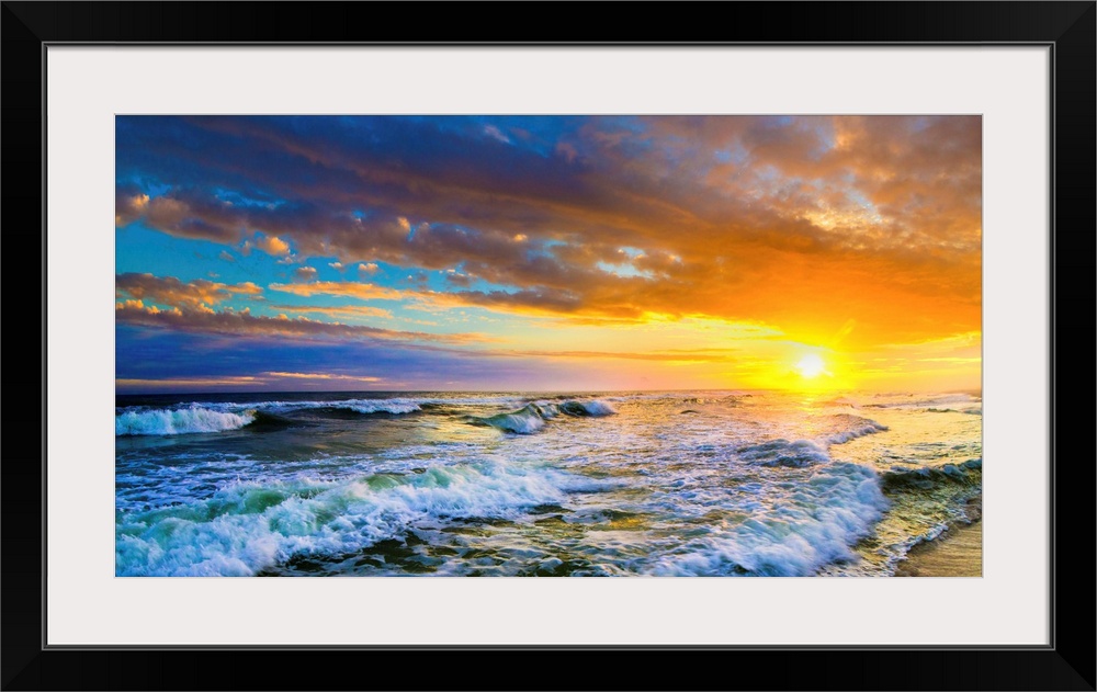 A beautiful red sunset panorama of an ocean sunset. This landscape features a red ocean sunset with waves.