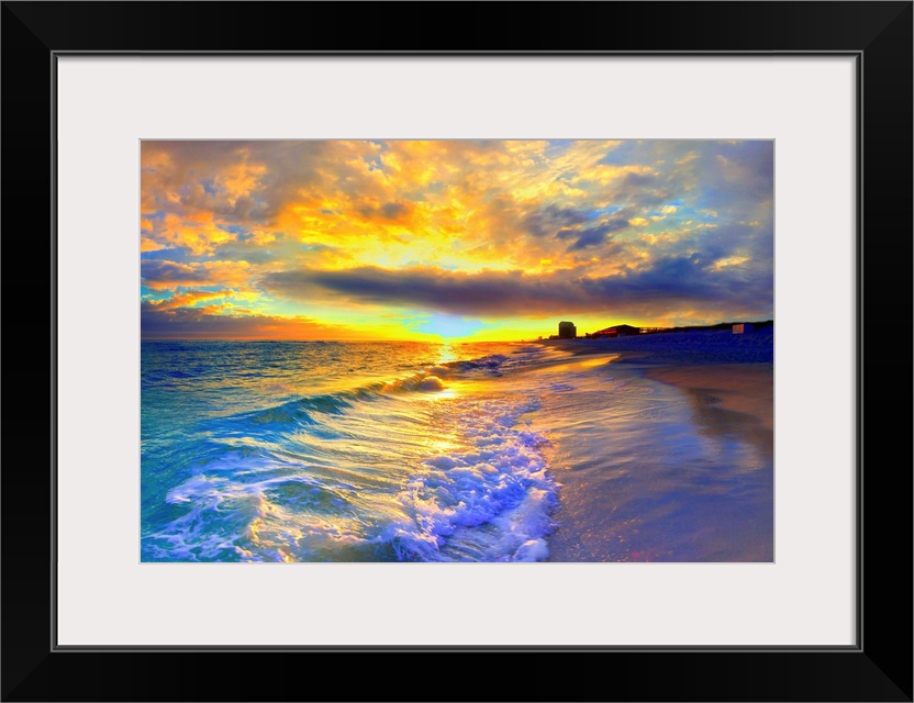 A beautiful yellow sunrise with foaming ocean waves striking the beach. Yellow clouds burst into the sky over a beautiful ...