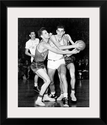 Adolph 'Dolph' Schayes keeping the basketball away from Joe Ossola