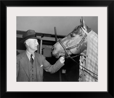 Charles Howard admiring his horse Seabiscuit, March 5, 1940