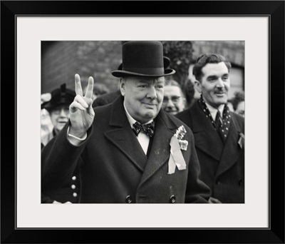 Conservative Party Leader Winston Churchill gives his familiar victory sign
