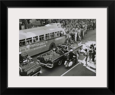 Dallas crowds waving as President Kennedy's limousine drives through downtown Dallas