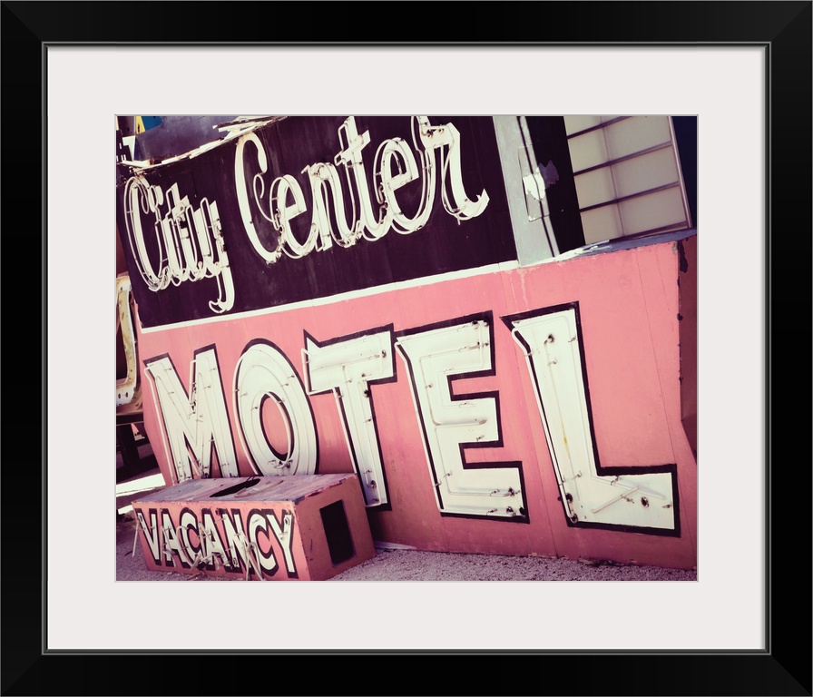 Photograph of a pink and maroon vintage City Center Motel sign from a unique angle.