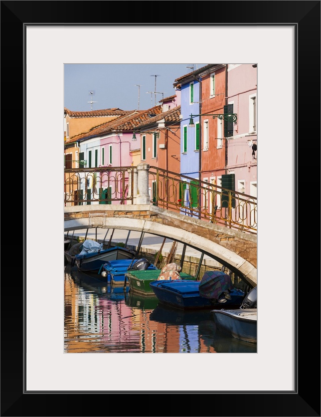 Italy, Burano. Reflection of colorful houses in canal.