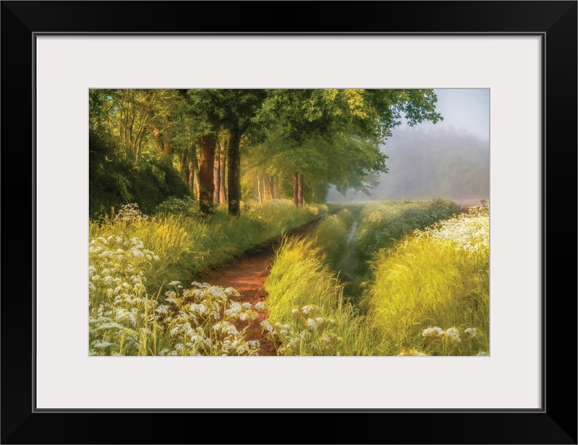 A photo with a semblance of a painting displays a hidden pathway in a meadow during spring.