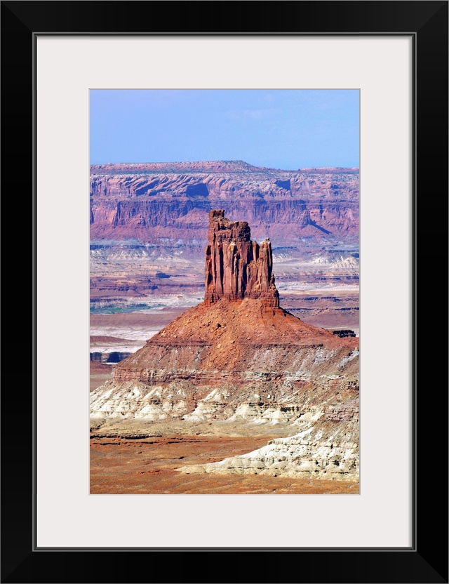 A tall rock formation in the desert landscape of Utah.