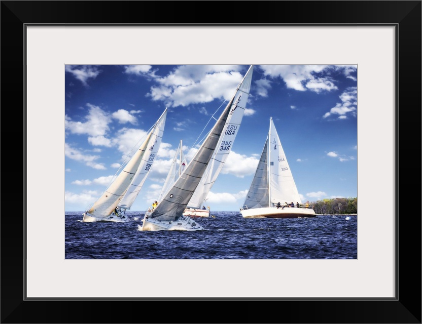 Three white sailboats on the water under a cloudy blue sky.