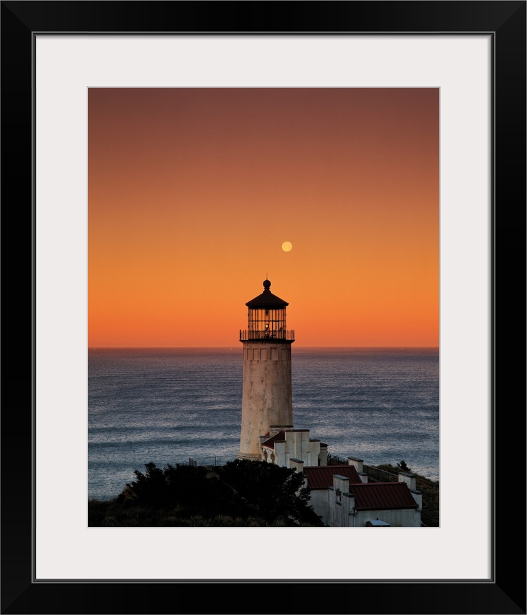 A lighthouse overlooking the ocean at sunset, Washington.