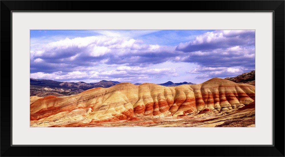 Large white clouds over the Painted Hills in Oregon.