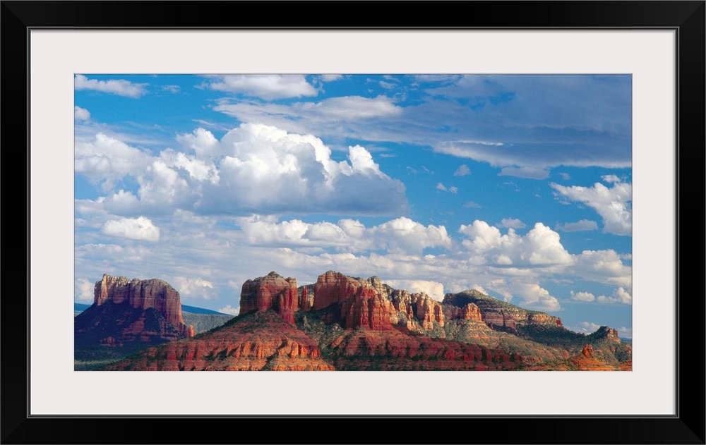 Large white clouds over the desert landscape of Sedona, Arizona.