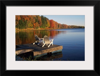 Adirondack Chairs On Dock At Lake