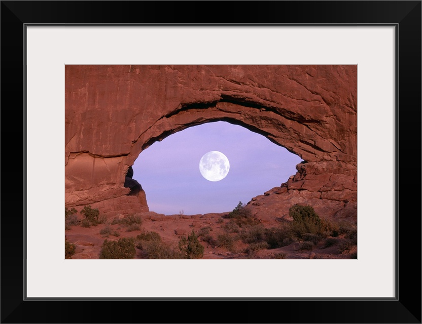 PHOTOGRAPHER AT WINDOW AT ARCHES NATIONAL PARK