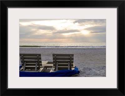 Beach chairs on St. Petersburg beach at sunset