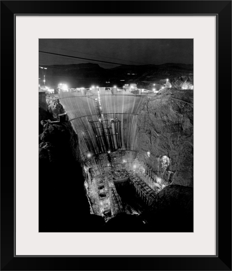 Floodlights illuminate Boulder Dam at night during construction. Boulder Dam, now called Hoover Dam is one of the world's ...