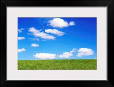 Clouds In Blue Sky Over Green Grass