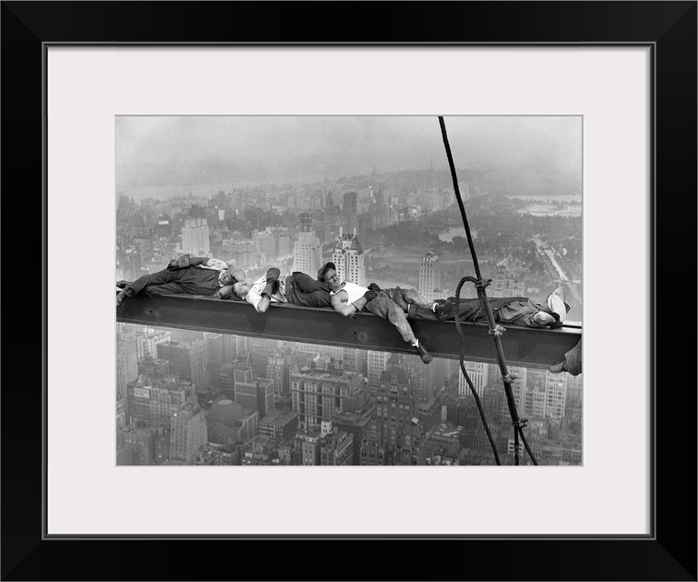 Four construction workers take a nap, balanced on a steel girder hung 800 feet over Manhattan, during the construction of ...