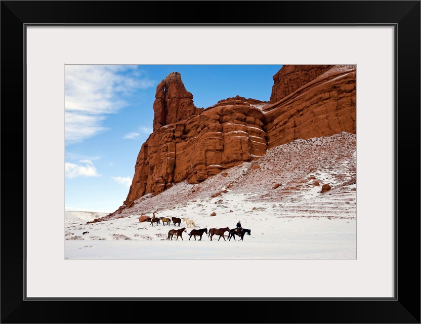 Cowboys from Hide Out Ranch herd American quarter horses in the Big Horn Mountains of Wyoming in Winter.