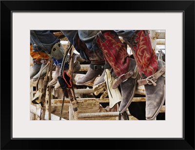 Cowboys sitting on a cattle stall