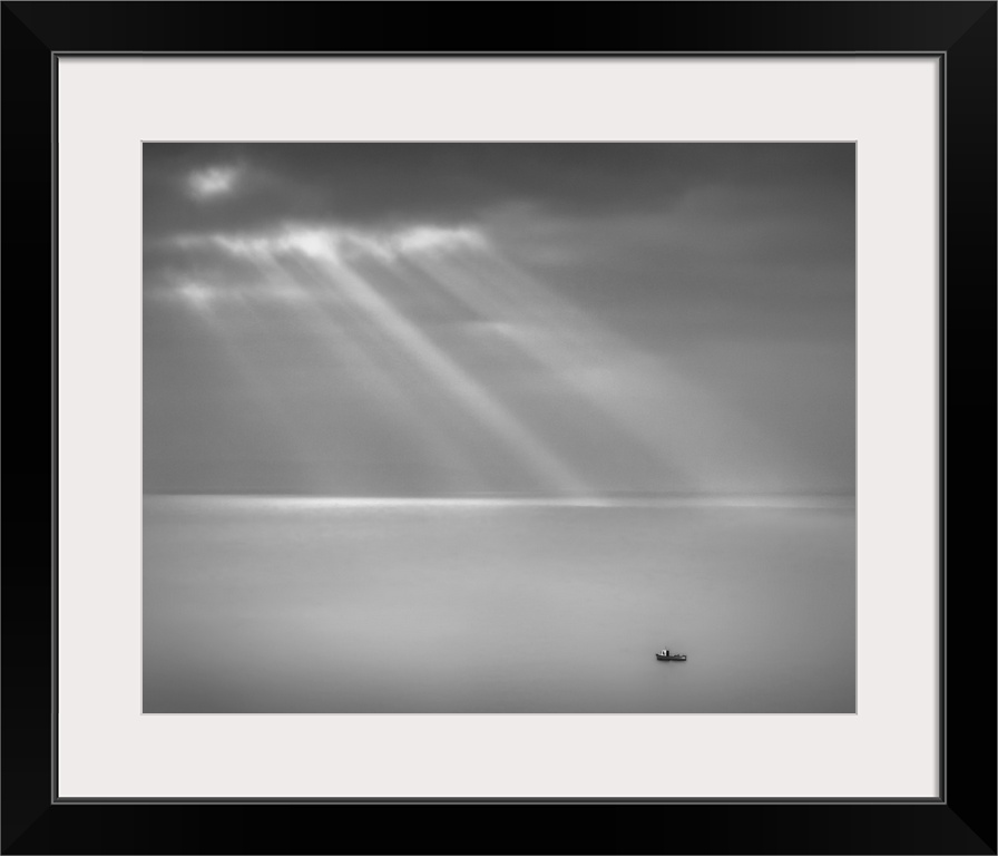 Crespecular rays over lone fishing boat in Bristol Channel off Brean Down, England, UK.