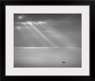 Crespecular rays over lone fishing boat in Bristol Channel off Brean Down, England, UK.