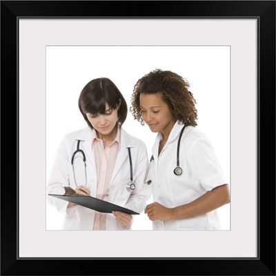 Doctors looking at clipboard