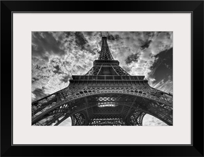 Eiffel tower and cloudy sky in Paris.