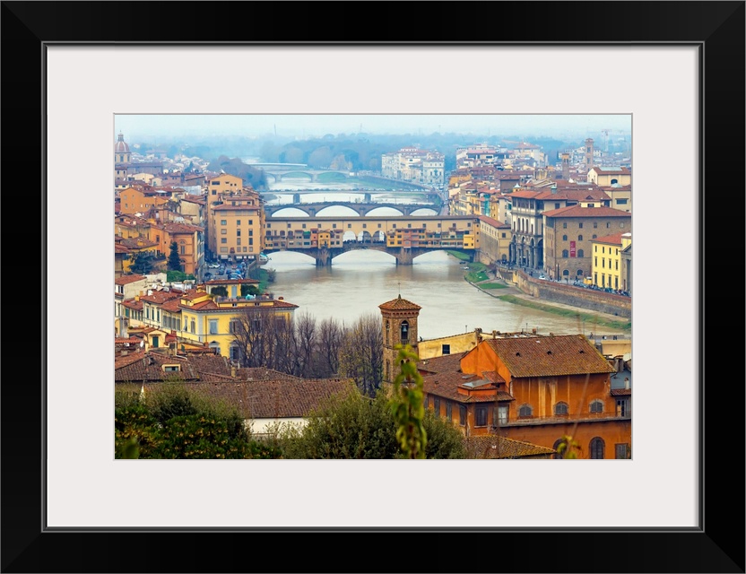 Giant photograph overlooking the Fiume Arno surrounded by a busy city within Italy.  On the shores of the river, the build...