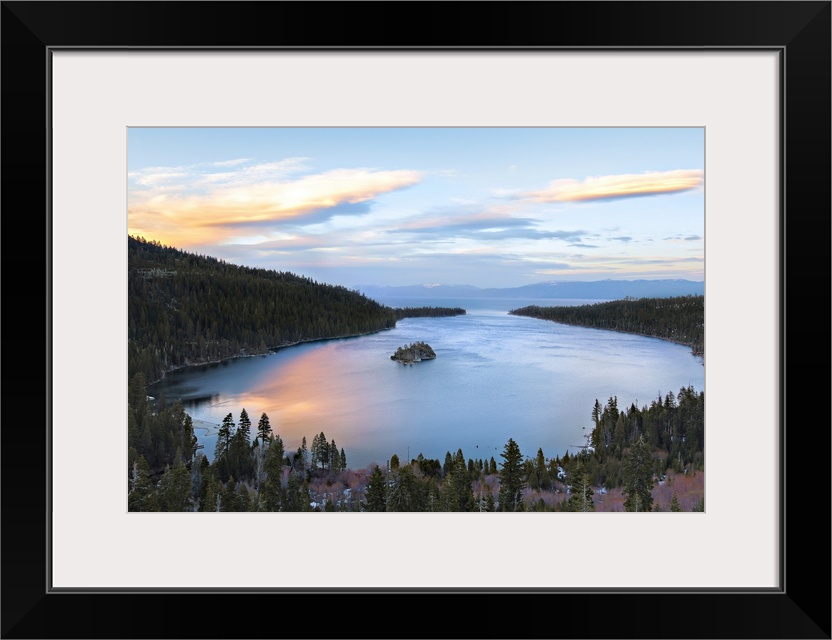 Emerald bay in lake Tahoe glows with reflection of springtime sunset.