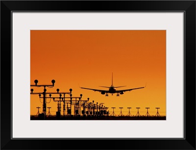 Landing of an airplane at sunset