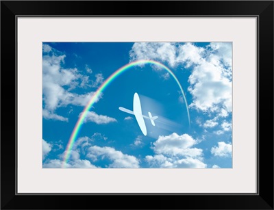Paper airplane flying through a blue sky and clouds towards a rainbow