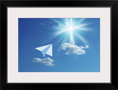 Paper airplane flying towards the sun