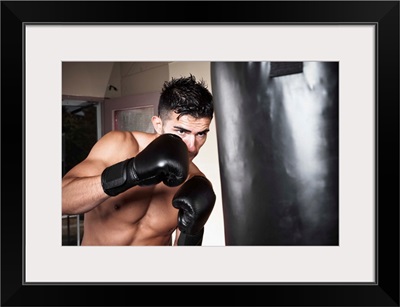 Portrait of young man boxing in gym